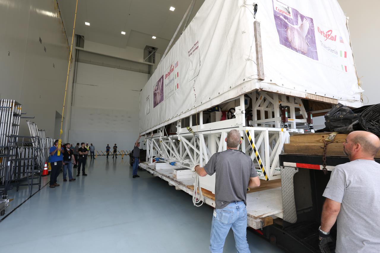 Inside the Space Station Processing Facility low bay at NASA’s Kennedy Space Center in Florida, technicians use a crane to lift the cover off ground support equipment for the Orbital ATK OA-7 commercial resupply services mission. The Orbital ATK CRS-7 with the Cygnus cargo module will lift off atop a United Launch Alliance Atlas V rocket from Space launch Complex 41 at Cape Canaveral Air Force Station. The commercial resupply services mission to the International Space Station will deliver thousands of pounds of supplies, equipment and scientific research materials that improve life on Earth and drive progress toward future space exploration. 