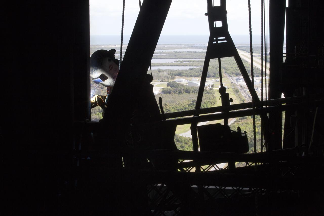 A construction worker solders a section of steel during the installation of the second half of the B-level work platforms, B north, for NASA's Space Launch System (SLS) rocket, in High Bay 3 in the Vehicle Assembly Building (VAB) at NASA's Kennedy Space Center in Florida. Construction workers will secure the large bolts that hold the platform in place on the north wall. The B platforms are the ninth of 10 levels of work platforms that will surround and provide access to the SLS rocket and Orion spacecraft for Exploration Mission 1. The Ground Systems Development and Operations Program is overseeing upgrades and modifications to VAB High Bay 3, including installation of the new work platforms, to prepare for NASA’s Journey to Mars. 
