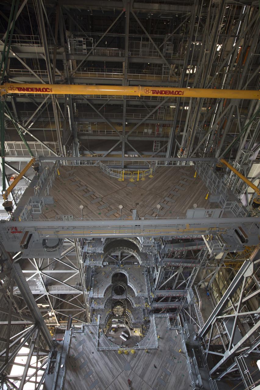 The second half of the B-level work platforms, B north, for NASA's Space Launch System (SLS) rocket, is lowered by crane for installation on the north side of High Bay 3 in the Vehicle Assembly Building (VAB) at NASA's Kennedy Space Center in Florida. Large Tandemloc bars have been attached to the platform to keep it level during lifting, lowering and installation. In view below are several levels of previously installed platforms. The B platforms are the ninth of 10 levels of work platforms that will surround and provide access to the SLS rocket and Orion spacecraft for Exploration Mission 1. The Ground Systems Development and Operations Program is overseeing upgrades and modifications to VAB High Bay 3, including installation of the new work platforms, to prepare for NASA’s Journey to Mars. 