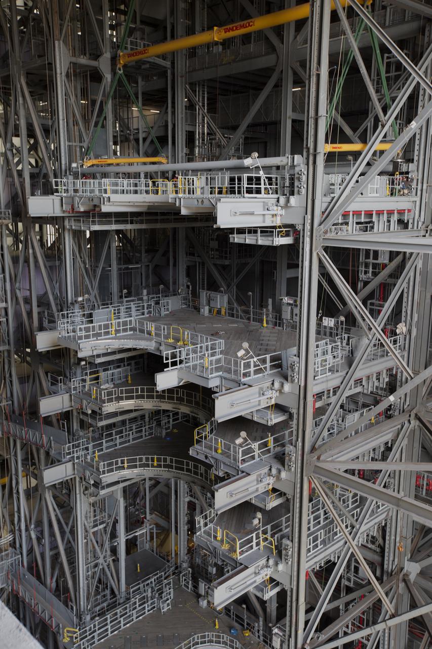 High up in the Vehicle Assembly Building (VAB) at NASA's Kennedy Space Center in Florida, the second half of the B-level work platforms, B north, for NASA's Space Launch System (SLS) rocket, has been lowered into place for installation on the north wall of High Bay 3. In view below are several levels of previously installed platforms. The B platforms are the ninth of 10 levels of work platforms that will surround and provide access to the SLS rocket and Orion spacecraft for Exploration Mission 1. The Ground Systems Development and Operations Program is overseeing upgrades and modifications to VAB High Bay 3, including installation of the new work platforms, to prepare for NASA’s Journey to Mars. 