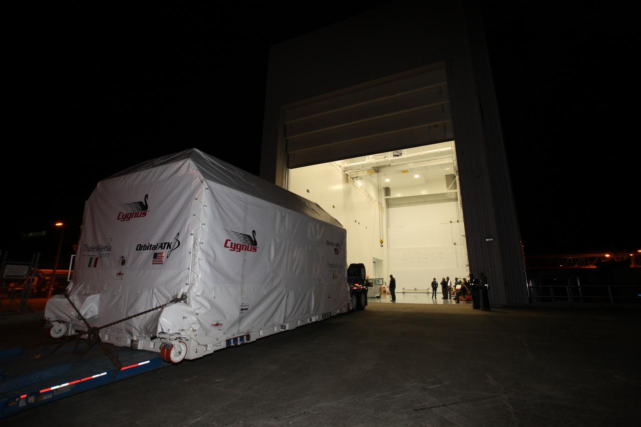 The Orbital ATK OA-7 Cygnus spacecraft's pressurized cargo module (PCM) arrives at the Space Station Processing Facility of NASA's Kennedy Space Center in Florida. The PCM is sealed in an environmentally controlled shipping container, pulled in by truck on a low-boy flatbed trailer. Scheduled to launch in March 2017, the Orbital ATK OA-7 mission will lift off atop a United Launch Alliance Atlas V rocket from Space launch Complex 41 at Cape Canaveral Air Force Station. The commercial resupply services mission to the International Space Station will deliver thousands of pounds of supplies, equipment and scientific research materials that improve life on Earth and drive progress toward future space exploration.