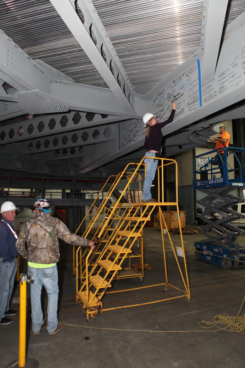 NASA Kennedy Space Center's Engineering Directorate coordinated a platform beam signing event to celebrate the culmination of the NASA and contractor team's last several years of study, design, construction and installation of 20 new work platforms in High Bay 3 of the Vehicle Assembly (VAB). Workers signed the final platform, A North, in the transfer aisle of the VAB. The platform will be lifted, installed and secured on its rail beam high up on the north wall of High Bay 3. The installation of the final topmost level completes the 10 levels of work platforms, 20 platform halves altogether, that will surround NASA's Space Launch System rocket and the Orion spacecraft and allow access during processing for missions, including the first uncrewed flight test of Orion atop the SLS rocket in 2018. The Ground Systems Development and Operations Program, with support from the center's Engineering Directorate, is overseeing upgrades and modifications to the VAB, including installation of the new work platforms.