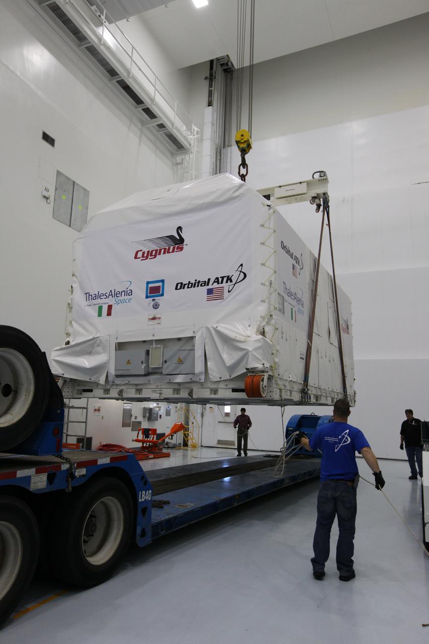 A crane is used to lift the Orbital ATK OA-7 Cygnus spacecraft's pressurized cargo module (PCM) off a flatbed truck after arrival at the Space Station Processing Facility of NASA's Kennedy Space Center in Florida. The PCM is sealed in an environmentally controlled shipping container. Scheduled to launch on March 19, 2017, the Orbital ATK OA-7 mission will lift off atop a United Launch Alliance Atlas V rocket from Space launch Complex 41 at Cape Canaveral Air Force Station. The commercial resupply services mission to the International Space Station will deliver thousands of pounds of supplies, equipment and scientific research materials that improve life on Earth and drive progress toward future space exploration.