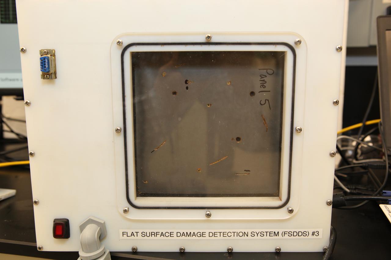The prototype Flexible Damage Detection System stands in a laboratory at NASA's Kennedy Space Center in Florida. The system uses circuits printed on thin thermal film and specialized software. The system is designed to show where damage to a surface occurs and how severe it may be. It could offer astronauts a real-time update on their spacecraft's condition during a mission without requiring a spacewalk.