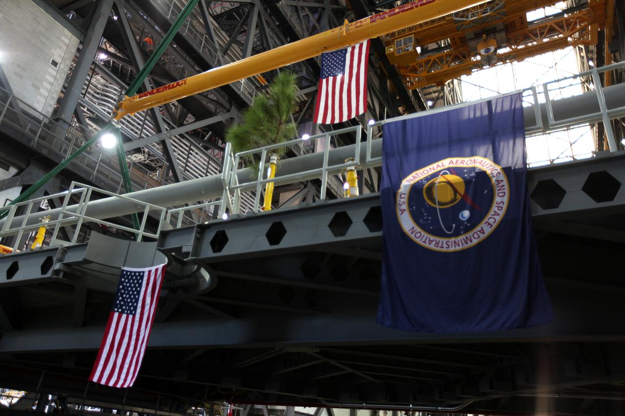 The American flag can be seen hanging from the final work platform, A north, as the platform is lifted up by crane from the transfer aisle in the Vehicle Assembly Building (VAB) at NASA's Kennedy Space Center in Florida. The platform will be installed and secured on its rail beam high up on the north wall of High Bay 3. The installation of the final topmost level completes the 10 levels of work platforms, 20 platform halves altogether, that will surround NASA's Space Launch System rocket and the Orion spacecraft and allow access during processing for missions, including the first uncrewed flight test of Orion atop the SLS rocket in 2018. The A-level platforms will provide access to the Orion spacecraft's Launch Abort System for Orion lifting sling removal and installation of the closeout panels. The Ground Systems Development and Operations Program, with support from the center's Engineering Directorate, is overseeing upgrades and modifications to the VAB, including installation of the new work platforms. 
