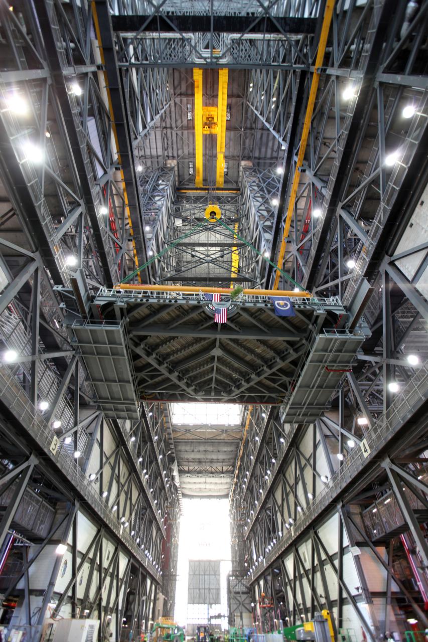 A crane lifts the final work platform, A north, up from the transfer aisle in the Vehicle Assembly Building (VAB) at NASA's Kennedy Space Center in Florida. The platform will be installed and secured on its rail beam high up on the north wall of High Bay 3. The installation of the final topmost level completes the 10 levels of work platforms, 20 platform halves altogether, that will surround NASA's Space Launch System rocket and the Orion spacecraft and allow access during processing for missions, including the first uncrewed flight test of Orion atop the SLS rocket in 2018. The A-level platforms will provide access to the Orion spacecraft's Launch Abort System for Orion lifting sling removal and installation of the closeout panels. The Ground Systems Development and Operations Program, with support from the center's Engineering Directorate, is overseeing upgrades and modifications to the VAB, including installation of the new work platforms.