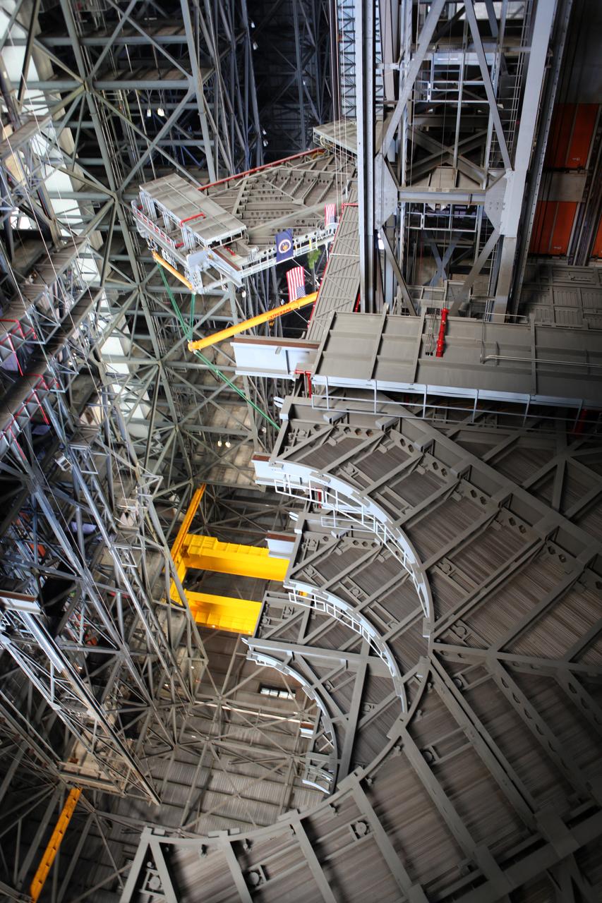 High up in the Vehicle Assembly Building (VAB) at NASA's Kennedy Space Center in Florida, a crane lowers the final work platform, A north, for installation in High Bay 3. The platform will be installed and secured on its rail beam high up on the north wall of the high bay. The installation of the final topmost level completes the 10 levels of work platforms, 20 platform halves altogether, that will surround NASA's Space Launch System rocket and the Orion spacecraft and allow access during processing for missions, including the first uncrewed flight test of Orion atop the SLS rocket in 2018. The A-level platforms will provide access to the Orion spacecraft's Launch Abort System for Orion lifting sling removal and installation of the closeout panels. The Ground Systems Development and Operations Program, with support from the center's Engineering Directorate, is overseeing upgrades and modifications to the VAB, including installation of the new work platforms.