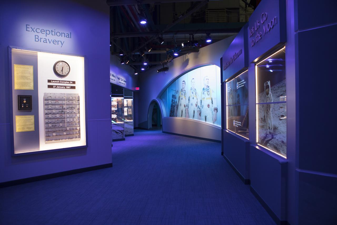 The new tribute to the crew of Apollo 1 who perished in a fire at the launch pad on Jan. 27, 1967, during training for the mission is shown looking down the length of the area. The tribute highlights the lives and careers of astronauts Gus Grissom, Ed White II and Roger Chaffee who were lost during the fire. The tribute at the Apollo/Saturn V Center at NASA's Kennedy Space Center opened Jan. 27, 2017, 50 years after the crew of three was lost. It features numerous items recalling the lives of the three astronauts. The tribute also includes the three-part hatch to the spacecraft itself, the first time any part of the Apollo 1 spacecraft has been displayed publicly. A version of the hatch after it was redesigned is also showcased as an example of improvements NASA made throughout the agency and to the Apollo spacecraft that would later carry astronauts to the moon. 