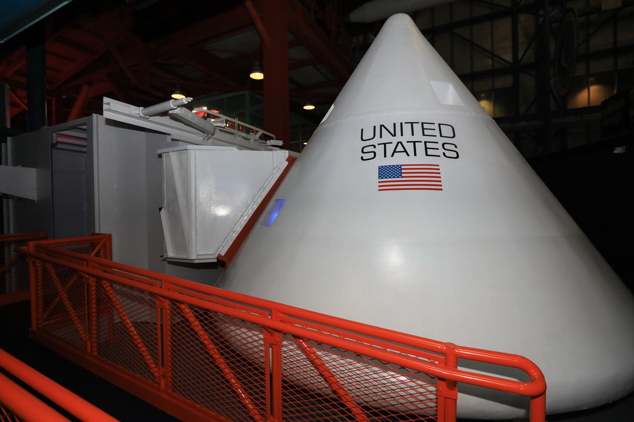 An Apollo spacecraft mockup marks the capstone of the new tribute to the crew of Apollo 1 who perished in a fire at the launch pad on Jan. 27, 1967, during training for the mission. The tribute highlights the lives and careers of astronauts Gus Grissom, Ed White II and Roger Chaffee who were lost during the fire. The tribute at the Apollo/Saturn V Center at NASA's Kennedy Space Center opened Jan. 27, 2017, 50 years after the crew of three was lost. It features numerous items recalling the lives of the three astronauts. The tribute also includes the three-part hatch to the spacecraft itself, the first time any part of the Apollo 1 spacecraft has been displayed publicly. A version of the hatch after it was redesigned is also showcased as an example of improvements NASA made throughout the agency and to the Apollo spacecraft that would later carry astronauts to the moon.