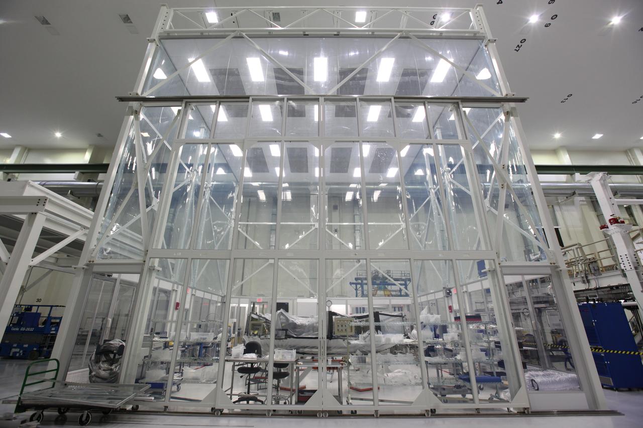 Inside the Neil Armstrong Operations and Checkout Building high bay at NASA's Kennedy Space Center in Florida, the Orion crew module adapter (CMA) for Exploration Mission 1 has been moved to a test stand inside a clean room. The adapter connects the crew module to the service module. NASA is preparing the CMA for further testing to prepare it for installation on the European Space Agency-provided service module for Orion. 