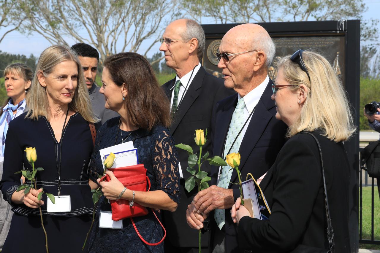 Following Kennedy Space Center's Day of Remembrance ceremony in the Center for Space Education at the Kennedy visitor complex, guests gathered to place flowers at the Space Mirror Memorial. Many of those in attendance were family members of the fallen astronauts.