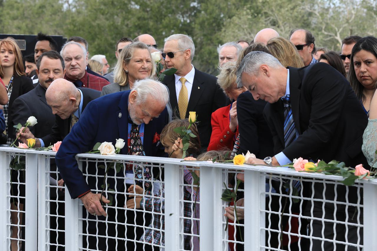 Following Kennedy Space Center's Day of Remembrance ceremony in the Center for Space Education at the Kennedy visitor complex, guests including astronauts Tom Stafford, left, and Buzz Aldrin, center, gathered to place flowers at the Space Mirror Memorial. Many of those in attendance were family members of the fallen astronauts.