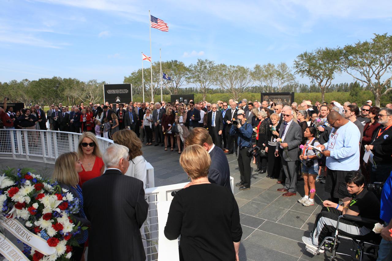 Following Kennedy Space Center's Day of Remembrance ceremony in the Center for Space Education at the Kennedy visitor complex, guests gathered to place flowers at the Space Mirror Memorial. Many of those in attendance were family members of the fallen astronauts.