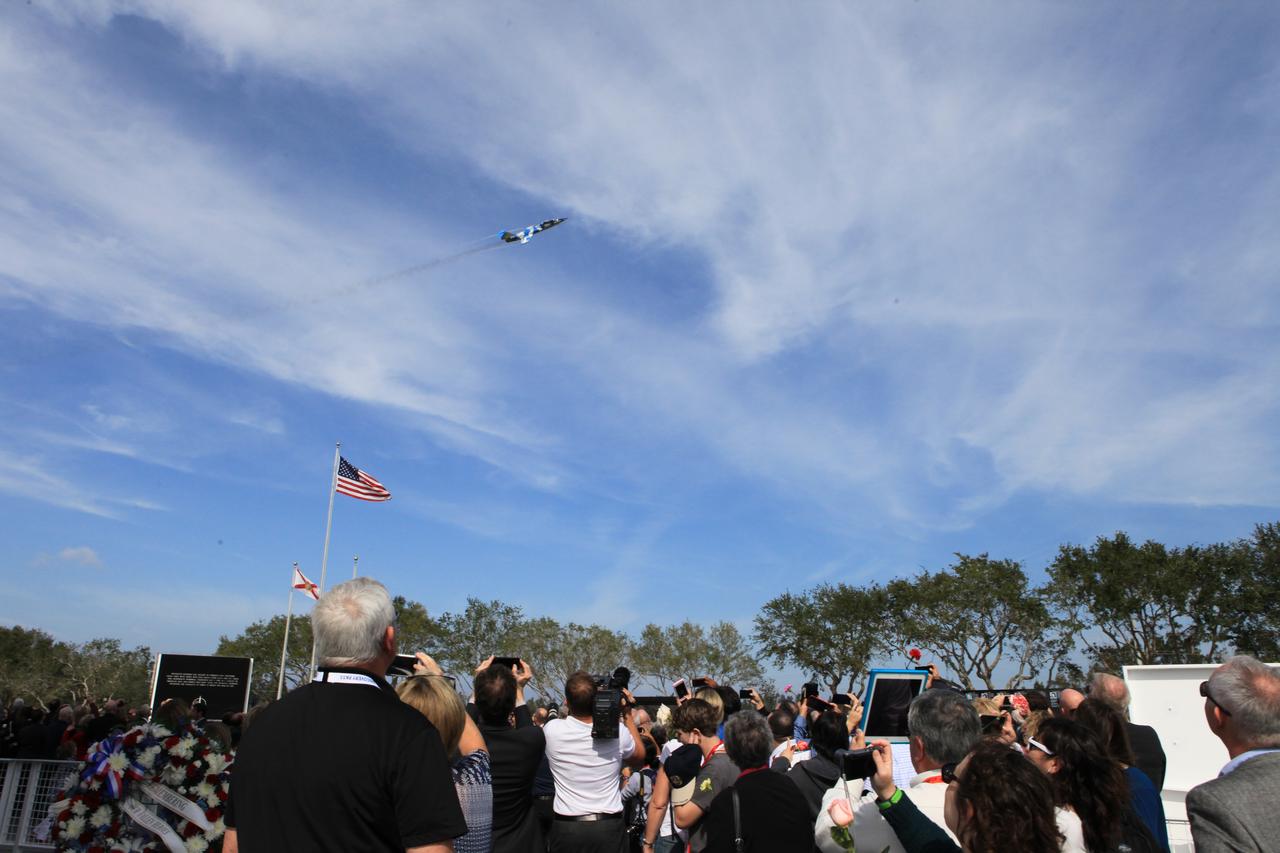 An F-104 Starfighter flies above a gathering of NASA officials, family members and other invited guests following Kennedy Space Center's Day of Remembrance ceremony at the Kennedy Space Center Visitor Complex. 