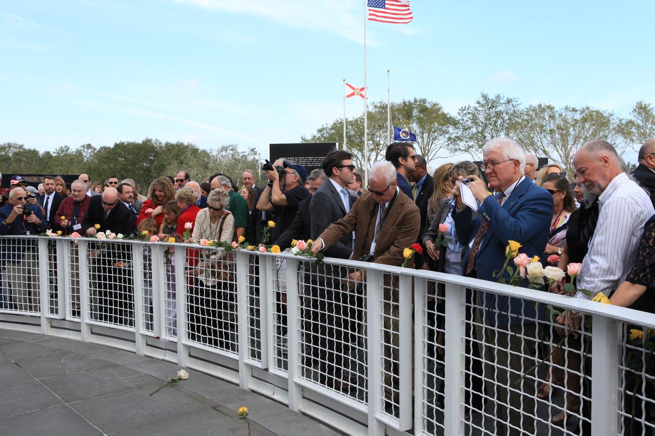 Following Kennedy Space Center's Day of Remembrance ceremony in the Center for Space Education at the Kennedy visitor complex, guests gathered to place flowers at the Space Mirror Memorial. Many of those in attendance were family members of the fallen astronauts.