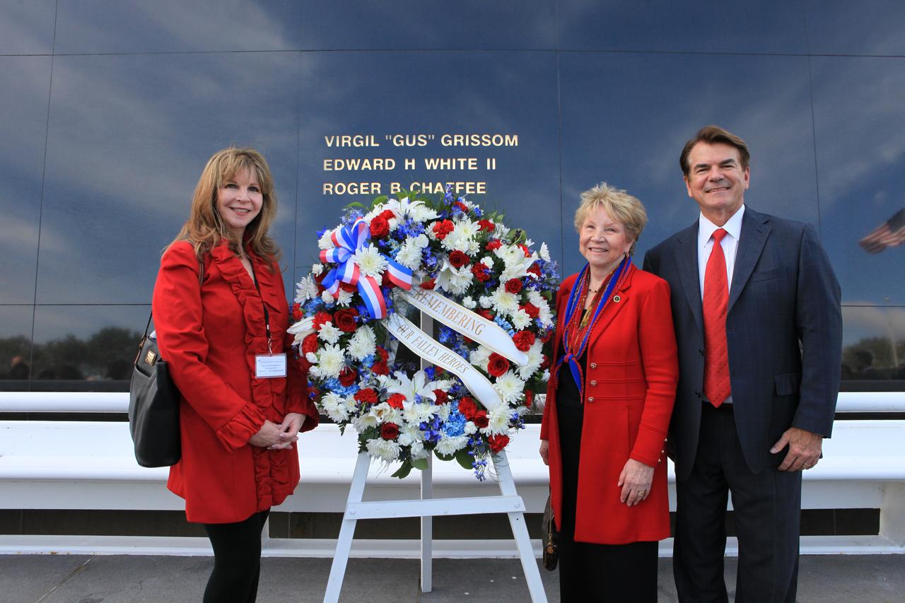Following the Kennedy Space Center's NASA Day of Remembrance ceremony, Family members of fallen astronauts placed a wreath at the Space Mirror Memorial. From the left, are Kathie Scobee Flugham, daughter of 51-L Challenger astronaut Dick Scobee, June Scobee Rodgers, Scobee's widow and State Rep. Thad Altman, president and chief executive officer of the Astronauts Memorial Foundation. They are standing in front of the memorial includes the names of the fallen astronauts from Apollo 1, Challenger and Columbia, as well as the astronauts who perished in training and commercial airplane accidents are emblazoned on the monument's 45-foot-high-by-50-foot-wide polished black granite surface.
