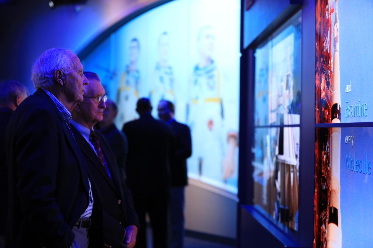 Guests observe areas of the newly opened Apollo 1 tribute at the Apollo/Saturn V Center at NASA's Kennedy Space Center opened Jan. 27, 2017. Astronauts Gus Grissom, Ed White II and Chaffee perished in a fire at the launch pad on Jan. 27, 1967, during training for the mission. The tribute highlights the lives and careers of the astronauts. The tribute features numerous items recalling the lives of the three astronauts. The tribute also includes the three-part hatch to the spacecraft itself, the first time any part of the Apollo 1 spacecraft has been displayed publicly. A version of the hatch after it was redesigned is also showcased as an example of improvements NASA made throughout the agency and to the Apollo spacecraft that would later carry astronauts to the moon. 