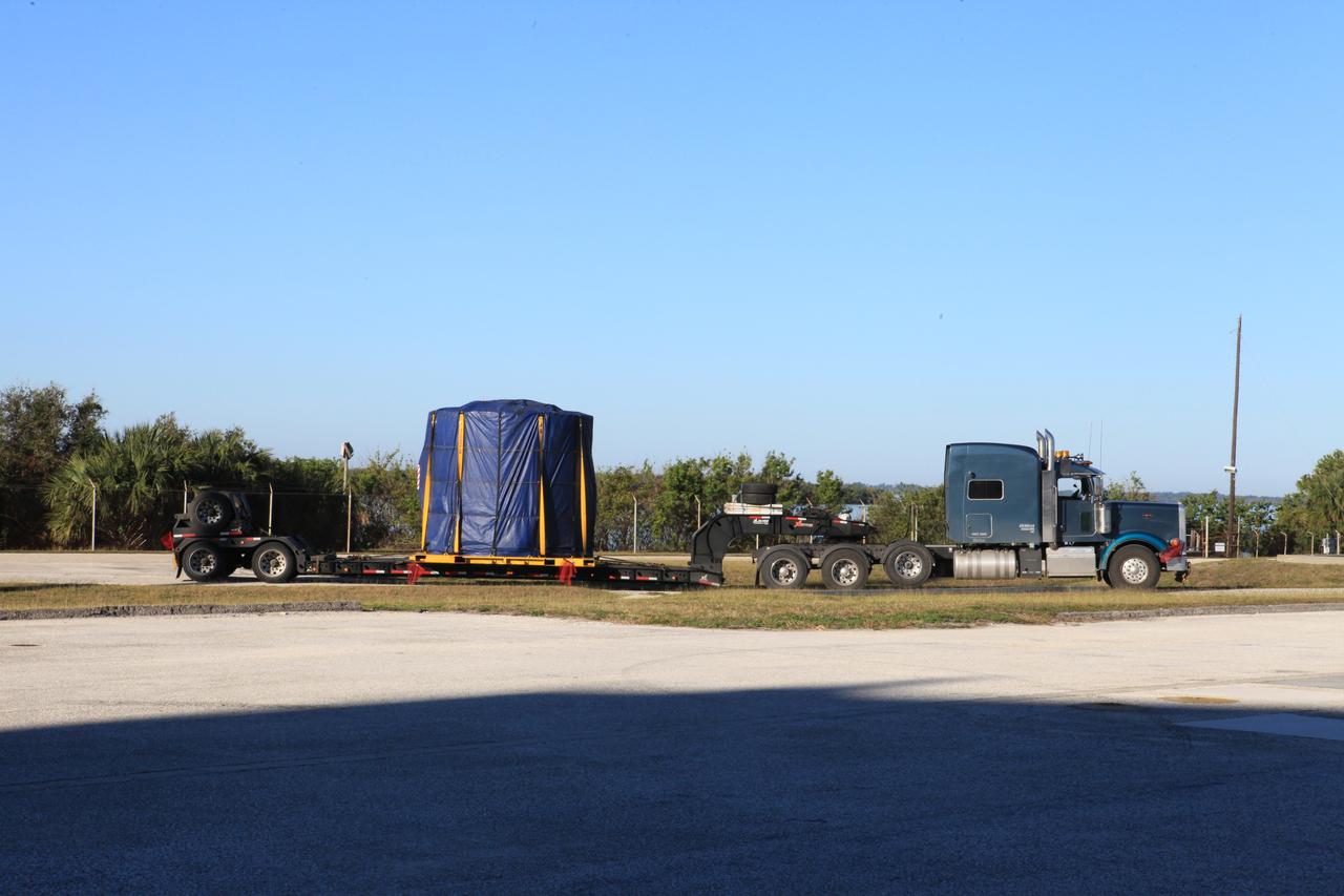 The left-hand forward skirt for NASA's Space Launch System (SLS) solid rocket boosters arrives by flatbed truck from booster prime contractor Orbital ATK in Promontory, Utah, to Cape Canaveral Air Force Station in Florida. The forward skirt will be delivered to the Hangar AF facility where refurbishment will continue. The forward skirt will be inspected and prepared for use on the left-hand solid rocket booster for Exploration Mission 1. NASA's Orion spacecraft will fly atop the SLS rocket on its first uncrewed flight test. 
