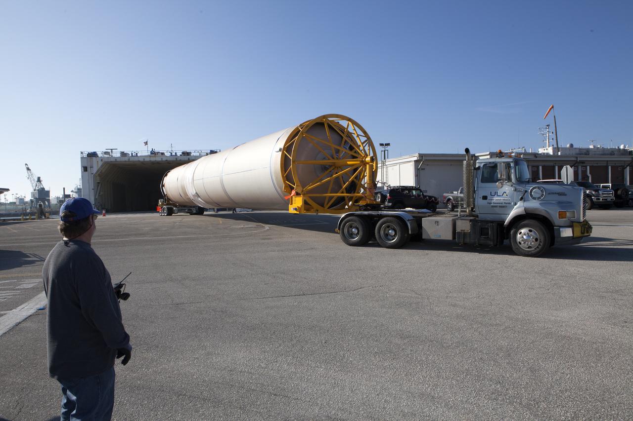 The United Launch Alliance (ULA) Atlas V booster arrives for the Orbital ATK CRS-7 commercial resupply mission to the International Space Station. A transport truck is taking the Atlas V from the Mariner cargo ship in the background, to the hangar at the Atlas Spaceflight Operations Center (ASOC), located south of Space Launch Complex 41 at Cape Canaveral Air Force Station. Scheduled to launch March 19, 2017, the Orbital ATK CRS-7 mission will lift off atop the ULA Atlas V rocket to deliver thousands of pounds of supplies, equipment and scientific research materials that improve life on Earth and drive progress toward future space exploration.