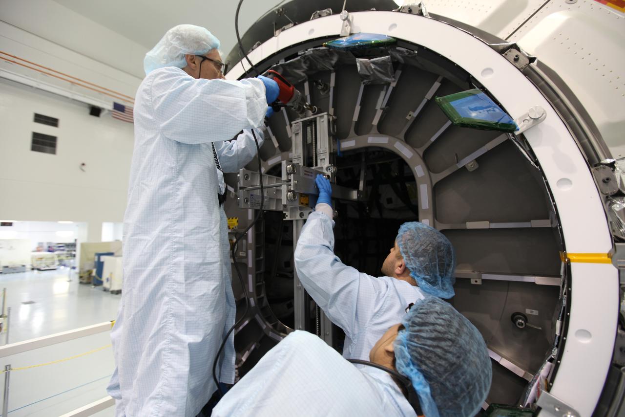In the Space Station Processing Facility at NASA's Kennedy Space Center in Florida, technicians help secure the hatch for closure on the Cygnus spacecraft's pressurized cargo module (PCM) for the Orbital ATK CRS-7 mission to the International Space Station. Scheduled to launch on March 19, 2017, the commercial resupply services mission will lift off atop a United Launch Alliance Atlas V rocket from Space launch Complex 41 at Cape Canaveral Air Force Station.