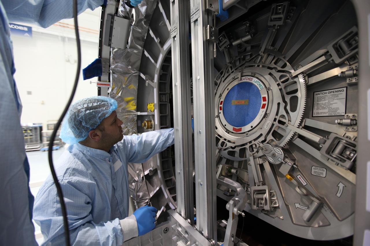 In the Space Station Processing Facility at NASA's Kennedy Space Center in Florida, a technician helps secure the hatch for closure on the Cygnus spacecraft's pressurized cargo module (PCM) for the Orbital ATK CRS-7 mission to the International Space Station. Scheduled to launch on March 19, 2017, the commercial resupply services mission will lift off atop a United Launch Alliance Atlas V rocket from Space launch Complex 41 at Cape Canaveral Air Force Station. 