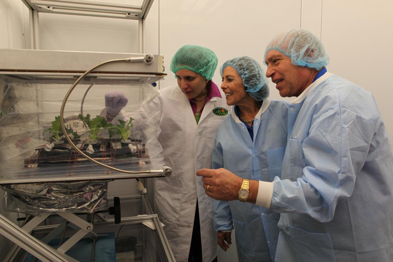 Gioia Massa, NASA payload scientist for Veggie, left, Betty and Ed Rosenthal, founders of Florikan Fertilizer Corp., observe ground control experiments in the Veggie Lab at NASA's Kennedy Space Center on Feb. 16. 