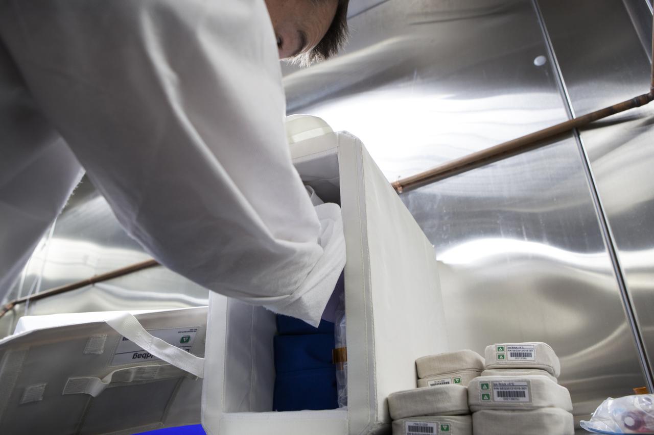 APEX-04, or Advanced Plant EXperiments-04, is being prepared in a cold room in the Kennedy Space Center Processing Facility for SpaceX-10. Eric Morris from the cold stowage group fits items into the Double Cold Bag (DCB) which is a non-powered container that keeps the APEX petri plates at +4 degrees Celsius during launch and ascent.. Dr. Anna Lisa Paul of the University of Florida is the principal investigator for APEX-04. Apex-04 is an experiment involving Arabidopsis in petri plates inside the Veggie facility aboard the International Space Station. Since Arabidopsis is the genetic model of the plant world, it is a perfect sample organism for performing genetic studies in spaceflight. The experiment is the result of a grant from NASA’s Space Life and Physical Sciences division.
