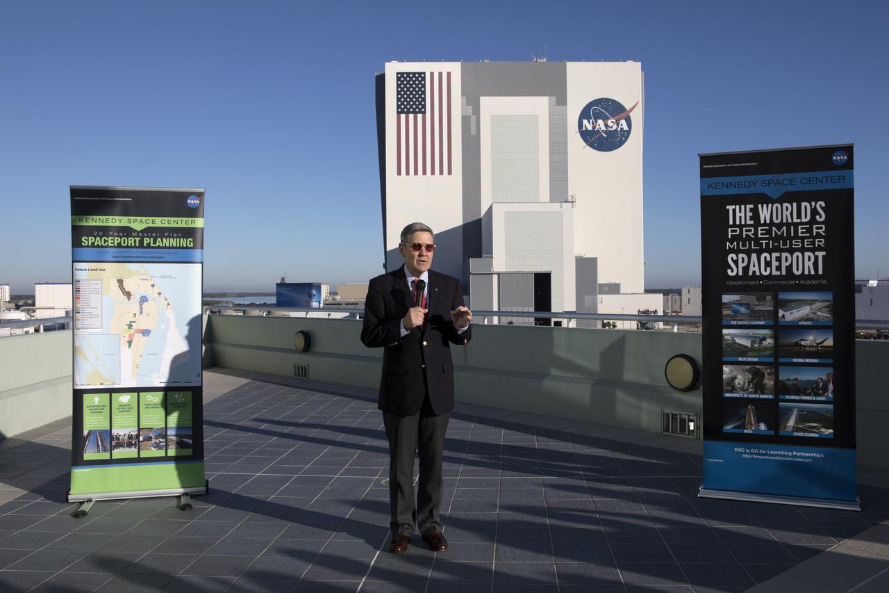 Kennedy Space Center Director Bob Cabana speaks to members of the news media on the balcony of Operations Support Building II describing the site's transition from a primarily government-only facility to a premier, multi-user spaceport. In the background is the Vehicle Assembly Building (VAB). Modifications were recently completed in the VAB where new work platforms were installed to support processing of NASA's Space Launch System rocket designed to send the Orion spacecraft on missions beyond low-Earth orbit.