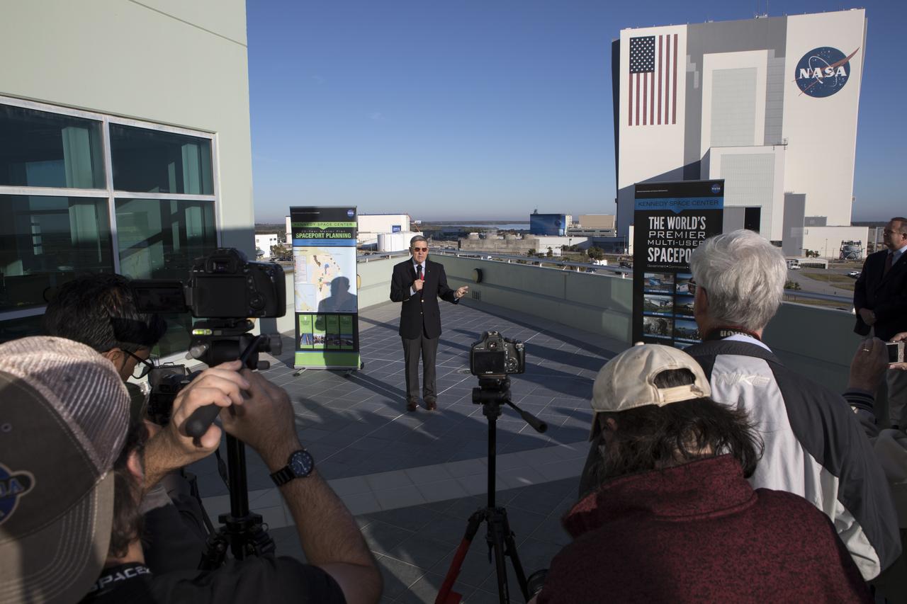Kennedy Space Center Director Bob Cabana speaks to members of the news media on the balcony of Operations Support Building II describing the site's transition from a primarily government-only facility to a premier, multi-user spaceport. In the background is the Vehicle Assembly Building (VAB). Modifications were recently completed in the VAB where new work platforms were installed to support processing of NASA's Space Launch System rocket designed to send the Orion spacecraft on missions beyond low-Earth orbit.