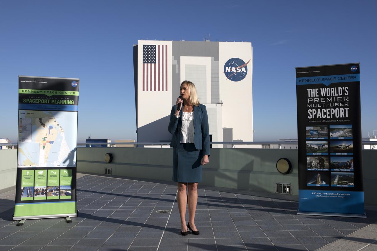 Nancy Bray, director of Spaceport Integration and Services at NASA's Kennedy Space Center, speaks to members of the news media on the balcony of Operations Support Building II describing the site's transition from a primarily government-only facility to a premier, multi-user spaceport. In the background is the Vehicle Assembly Building (VAB). Modifications were recently completed in the VAB where new work platforms were installed to support processing of NASA's Space Launch System rocket designed to send the Orion spacecraft on missions beyond low-Earth orbit.