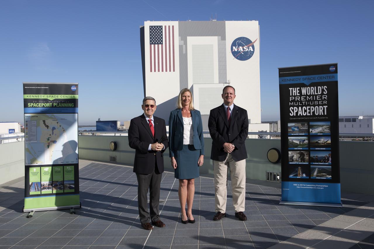 Kennedy Space Center Director Bob Cabana, left, was joined by Nancy Bray, director of Spaceport Integration and Services, center, and Tom Engler, director of Center Planning and Development in briefing members of the news media on the balcony of Operations Support Building II. They described Kennedy's transition from a primarily government-only facility to a premier, multi-user spaceport. In the background is the Vehicle Assembly Building (VAB). Modifications were recently completed in the VAB where new work platforms were installed to support processing of NASA's Space Launch System rocket designed to send the Orion spacecraft on missions beyond low-Earth orbit.