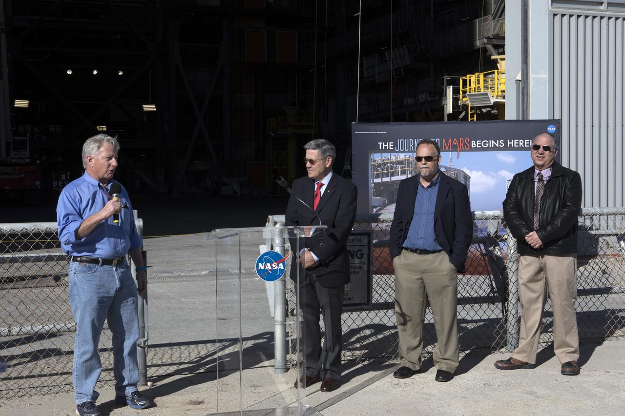 Members of the news media viewed the 10 levels of new work platforms in High Bay 3 inside the Vehicle Assembly Building during a multi-user tour of NASA's Kennedy Space Center in Florida with Center Director Bob Cabana. The final platform, A north, was recently installed. From left are Kerry Chreist of Jacobs on the Test and Operations Support Contract; Cabana; Shawn Quinn, associate program manager for the Ground Systems Development and Operations Program (GSDO); and Jose Perez-Morales, GSDO project manager for platform installation. The platforms will surround the Space Launch System and Orion spacecraft on the mobile launcher during processing to prepare for the first test flight.