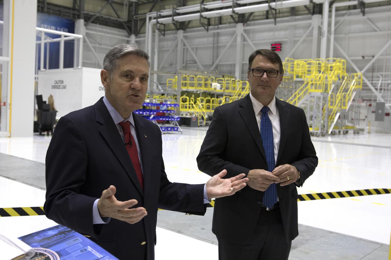 Kennedy Space Center Director Bob Cabana, left, and John Mulholland, Boeing vice president and program manager for Commercial Programs, speak to members of the news media inside the Boeing’s Commercial Crew and Cargo Processing Facility at the Florida spaceport. The facility will be used in manufacturing Boeing's CST-100 Starliner spacecraft for flight tests and crew rotation missions to the International Space Station as part of the agency's Commercial Crew Program.