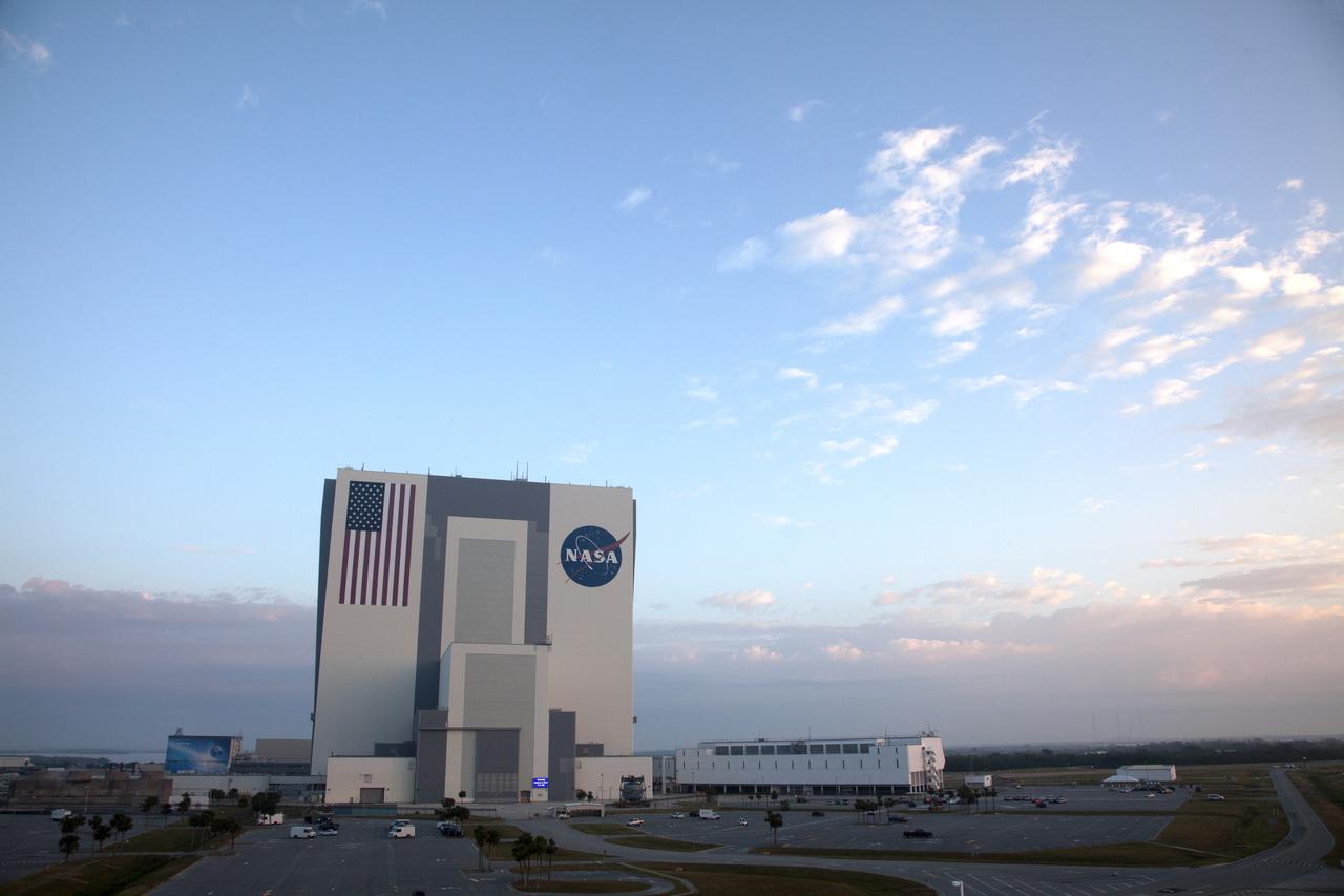 An early morning view of the iconic Vehicle Assembly Building (VAB) at NASA's Kennedy Space Center in Florida. To the right is the Launch Control Center. All 10 levels of new work platforms, 20 platform halves altogether, have been installed in VAB High Bay 3 for the agency's Space Launch System (SLS) rocket and Orion spacecraft. The Ground Systems Development and Operations Program is overseeing upgrades to the VAB, including installation of the new platforms to prepare for the first test flight of Orion atop the SLS from Launch Pad 39B.