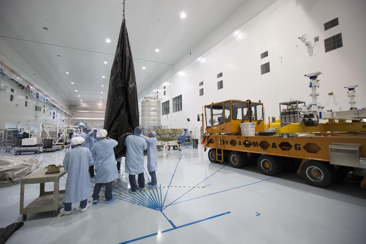 In the Space Station Processing Facility at NASA's Kennedy Space Center in Florida, a KAMAG transporter has arrived in the high bay. Technicians are preparing the protective covering for Orbital ATK's CYGNUS pressurized cargo module. The Orbital ATK CRS-7 commercial resupply services mission to the International Space Station is scheduled to launch atop a United Launch Alliance Atlas V rocket from Space Launch Complex 41 at Cape Canaveral Air Force Station on March 19, 2017. CYGNUS will deliver thousands of pounds of supplies, equipment and scientific research materials to the space station.