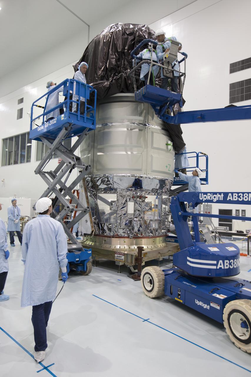 In the Space Station Processing Facility high bay at NASA's Kennedy Space Center in Florida, technicians position a protective covering around Orbital ATK's CYGNUS pressurized cargo module. The Orbital ATK CRS-7 commercial resupply services mission to the International Space Station is scheduled to launch atop a United Launch Alliance Atlas V rocket from Space Launch Complex 41 at Cape Canaveral Air Force Station on March 19, 2017. CYGNUS will deliver thousands of pounds of supplies, equipment and scientific research materials to the space station.