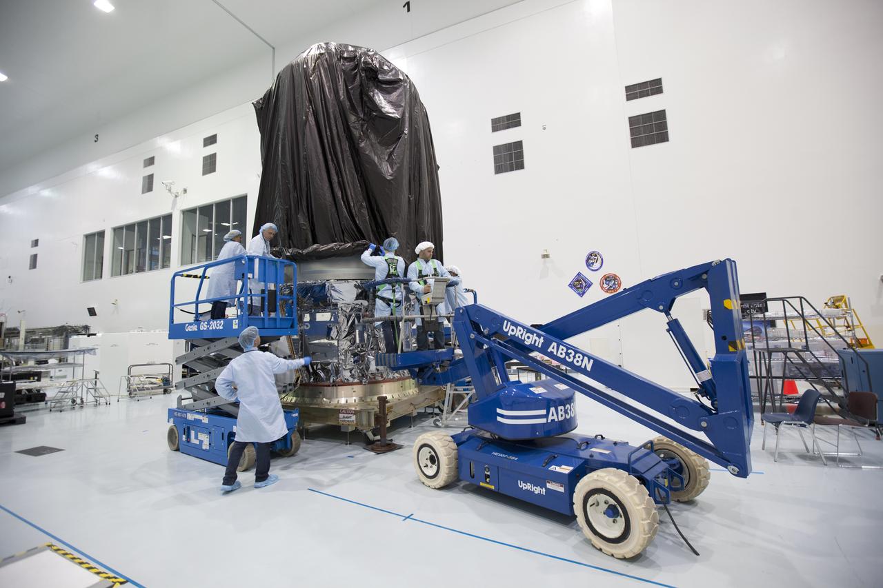 In the Space Station Processing Facility high bay at NASA's Kennedy Space Center in Florida, technicians secure a protective covering around Orbital ATK's CYGNUS pressurized cargo module. The Orbital ATK CRS-7 commercial resupply services mission to the International Space Station is scheduled to launch atop a United Launch Alliance Atlas V rocket from Space Launch Complex 41 at Cape Canaveral Air Force Station on March 19, 2017. CYGNUS will deliver thousands of pounds of supplies, equipment and scientific research materials to the space station.
