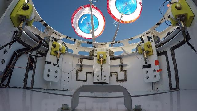 The parachute deployment is seen from the top hatch of a boilerplate CST-100 Starliner during a drop test of the Starliner's parachute system. Boeing, which is building the Starliner, conducted the test in White Sands, New Mexico, as part of the testing campaign for certification by NASA's Commercial Crew Program. Photo credit: Boeing