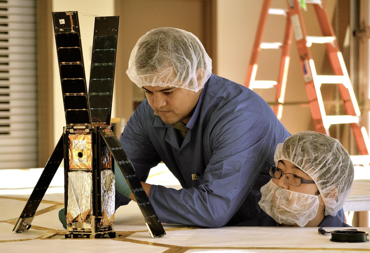 Students Alex Diaz and Riki Munakata of California Polytechnic State University testing the LightSail CubeSat. LightSail is a citizen-funded technology demonstration mission sponsored by the Planetary Society using solar propulsion for CubeSats. The spacecraft is designed to “sail” on the energy of solar photons striking the thin, reflective sail material. The first LightSail mission is designed to test the spacecraft’s critical systems, including the sequence to autonomously deploy a Mylar solar sail with an area of 32 square meters (344 square feet). The Planetary Society is planning a second, full solar sailing demonstration flight for 2016. Light is made of packets of energy called photons. While photons have no mass, they have energy and momentum. Solar sails use this momentum as a method of propulsion, creating flight by light. LightSail’s solar sail is packaged into a three-unit CubeSat about the size of a loaf of bread. Launched by NASA’s CubeSat Launch Initiative on the ELaNa XI mission as an auxiliary payload aboard the U.S. Air Force X-37B space plane mission on May 20, 2015.