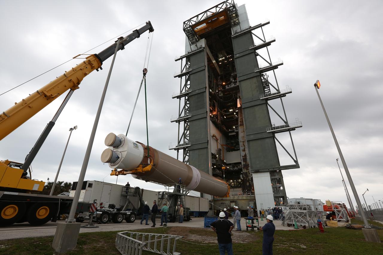 A crane lifts the first stage of the United Launch Alliance (ULA) Atlas V rocket up at the Vertical Integration Facility at Space Launch Complex 41 at Cape Canaveral Air Force Station in Florida. The rocket is being prepared for Orbital ATK's seventh commercial resupply mission, CRS-7, to the International Space Station. Orbital ATK's CYGNUS pressurized cargo module is scheduled to launch atop ULA's Atlas V rocket from Pad 41 on March 19, 2017. CYGNUS will deliver thousands of pounds of supplies, equipment and scientific research materials to the space station.