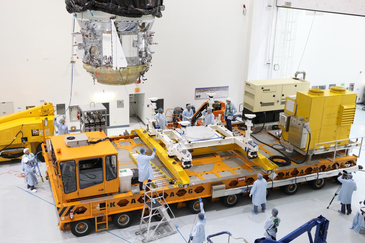 In the Space Station Processing Facility high bay at NASA's Kennedy Space Center in Florida, technicians monitor the progress as a crane moves the Orbital ATK CYGNUS pressurized cargo module closer to the KAMAG transporter. The module will be secured on the transporter and moved to the Payload Hazardous Servicing Facility. The Orbital ATK CRS-7 commercial resupply services mission to the International Space Station is scheduled to launch atop a United Launch Alliance Atlas V rocket from Space Launch Complex 41 at Cape Canaveral Air Force Station on March 19, 2017. CYGNUS will deliver thousands of pounds of supplies, equipment and scientific research materials to the space station. 