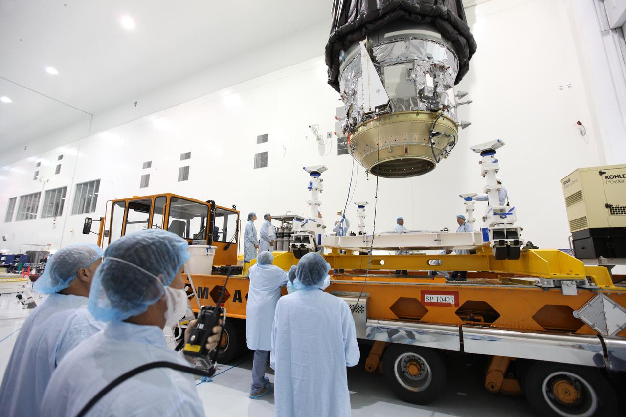In the Space Station Processing Facility high bay at NASA's Kennedy Space Center in Florida, technicians monitor the progress as a crane lowers the Orbital ATK CYGNUS pressurized cargo module toward the KAMAG transporter. The module will be secured on the transporter and moved to the Payload Hazardous Servicing Facility. The Orbital ATK CRS-7 commercial resupply services mission to the International Space Station is scheduled to launch atop a United Launch Alliance Atlas V rocket from Space Launch Complex 41 at Cape Canaveral Air Force Station on March 19, 2017. CYGNUS will deliver thousands of pounds of supplies, equipment and scientific research materials to the space station. 