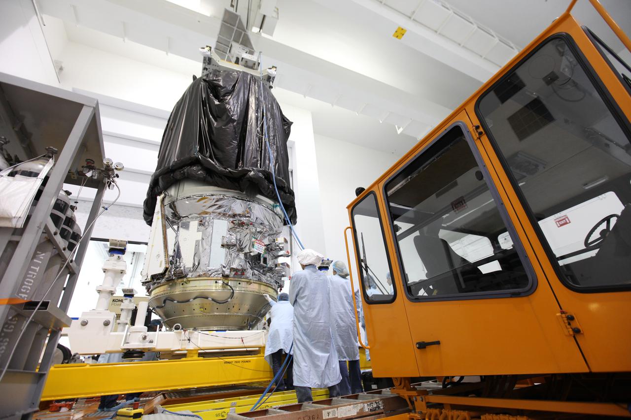 In the Space Station Processing Facility high bay at NASA's Kennedy Space Center in Florida, technicians secure the Orbital ATK CYGNUS pressurized cargo module on the KAMAG transporter. The module will be transported to the Payload Hazardous Servicing Facility. The Orbital ATK CRS-7 commercial resupply services mission to the International Space Station is scheduled to launch atop a United Launch Alliance Atlas V rocket from Space Launch Complex 41 at Cape Canaveral Air Force Station on March 19, 2017. CYGNUS will deliver thousands of pounds of supplies, equipment and scientific research materials to the space station.