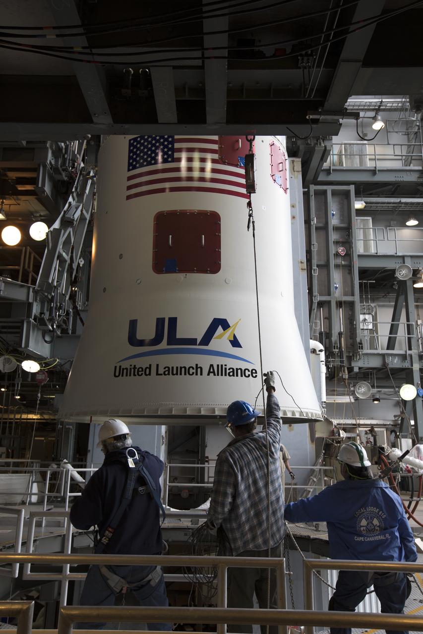 Technicians with United Launch Alliance (ULA) monitor the progress as a crane lifts the Centaur upper stage of the ULA Atlas V rocket up inside the Vertical Integration Facility at Space Launch Complex 41 at Cape Canaveral Air Force Station in Florida. The Centaur stage will be mated to the first stage booster. The rocket is being prepared for Orbital ATK's seventh commercial resupply mission, CRS-7, to the International Space Station. Orbital ATK's CYGNUS pressurized cargo module is scheduled to launch atop ULA's Atlas V rocket from Pad 41 on March 19, 2017. CYGNUS will deliver 7,600 pounds of supplies, equipment and scientific research materials to the space station.