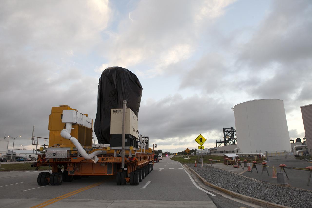 A KAMAG transporter with Orbital ATK's CYGNUS pressurized cargo module secured on top moves slowly along the road after exiting the Space Station Processing Facility at NASA's Kennedy Space Center in Florida. CYGNUS will be transported to the Payload Hazardous Servicing Facility for final propellant loading and late cargo stowage. The Orbital ATK CRS-7 commercial resupply services mission to the International Space Station is scheduled to launch atop a United Launch Alliance Atlas V rocket from Space Launch Complex 41 at Cape Canaveral Air Force Station on March 19, 2017. CYGNUS will deliver thousands of pounds of supplies, equipment and scientific research materials to the space station.