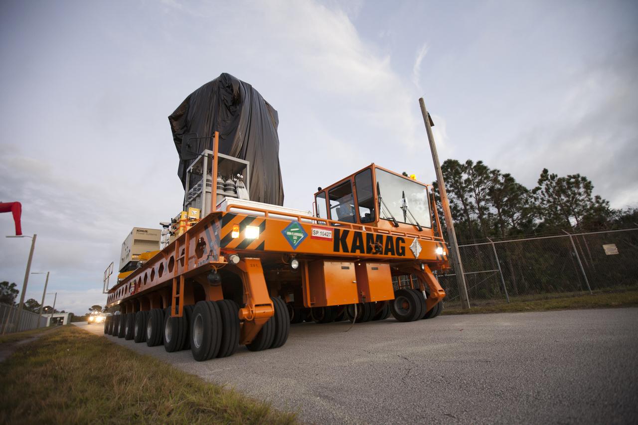A KAMAG transporter with Orbital ATK's CYGNUS pressurized cargo module secured on top moves slowly along the road after exiting the Space Station Processing Facility at NASA's Kennedy Space Center in Florida. CYGNUS will be transported to the Payload Hazardous Servicing Facility for final propellant loading and late cargo stowage. The Orbital ATK CRS-7 commercial resupply services mission to the International Space Station is scheduled to launch atop a United Launch Alliance Atlas V rocket from Space Launch Complex 41 at Cape Canaveral Air Force Station on March 19, 2017. CYGNUS will deliver thousands of pounds of supplies, equipment and scientific research materials to the space station. 
