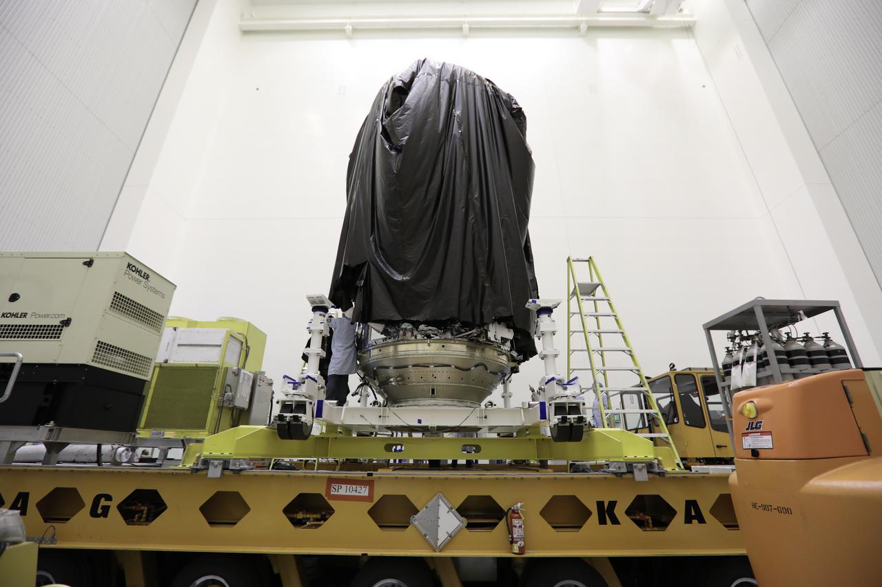 Inside the Payload Hazardous Servicing Facility at NASA's Kennedy Space Center in Florida, technicians begin to remove the protective covering from Orbital ATK's CYGNUS pressurized cargo module on a KAMAG transporter. In the PHSF, Cygnus will be move to a work stand for final propellant loading and late cargo stowage. The Orbital ATK CRS-7 commercial resupply services mission to the International Space Station is scheduled to launch atop a United Launch Alliance Atlas V rocket from Space Launch Complex 41 at Cape Canaveral Air Force Station on March 19, 2017. CYGNUS will deliver thousands of pounds of supplies, equipment and scientific research materials to the space station. 