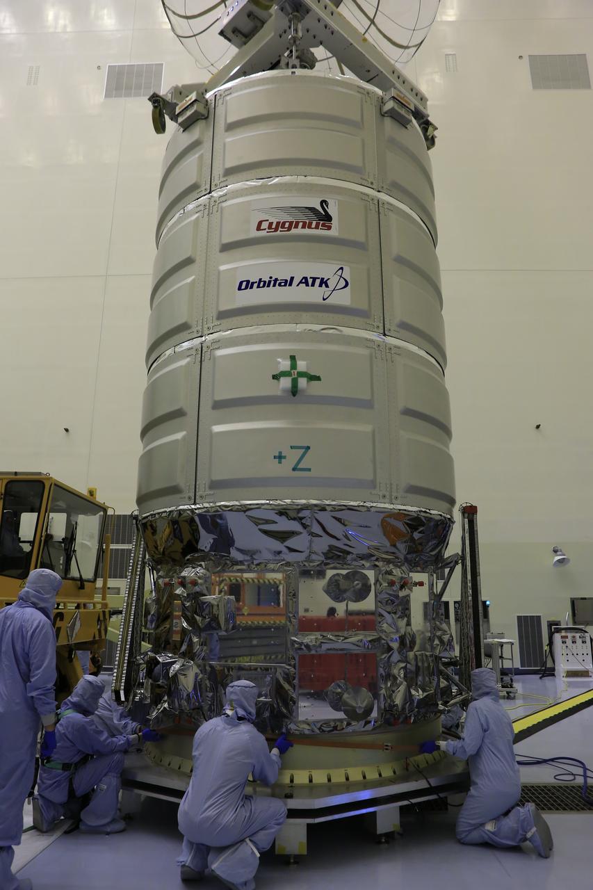Technicians assist as a crane lowers Orbital ATK's CYGNUS pressurized cargo module onto a work stand inside the Payload Hazardous Servicing Facility at NASA's Kennedy Space Center in Florida. CYGNUS will be secured on the work stand for final propellant loading and late cargo stowage. The Orbital ATK CRS-7 commercial resupply services mission to the International Space Station is scheduled to launch atop a United Launch Alliance Atlas V rocket from Space Launch Complex 41 at Cape Canaveral Air Force Station on March 19, 2017. CYGNUS will deliver thousands of pounds of supplies, equipment and scientific research materials to the space station.