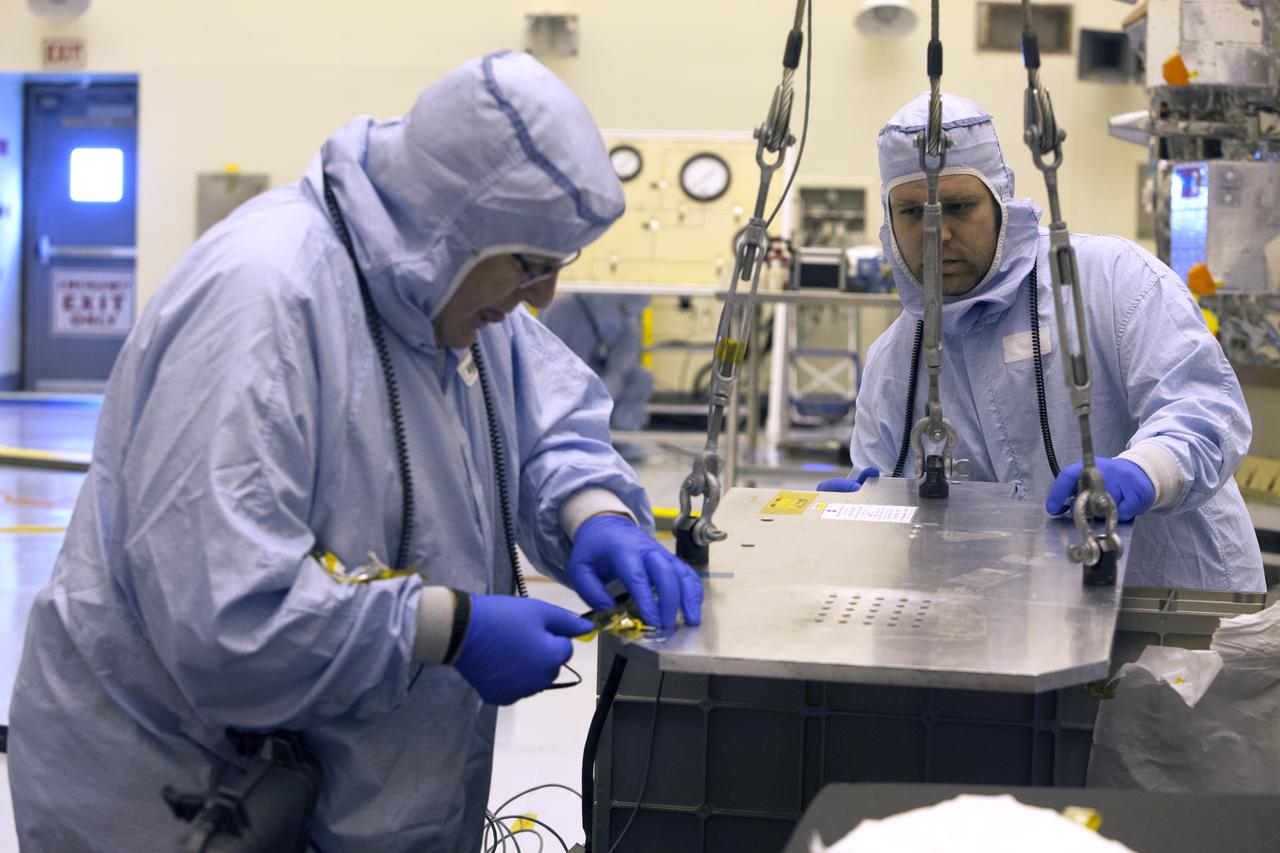 Inside the Payload Hazardous Servicing Facility at NASA's Kennedy Space Center in Florida, technicians prepare several Nanoracks for installation on the exterior of the Orbital ATK Cygnus pressurized cargo module. The Orbital ATK CRS-7 commercial resupply services mission to the International Space Station is scheduled to launch atop a United Launch Alliance Atlas V rocket from Space Launch Complex 41 at Cape Canaveral Air Force Station no earlier than March 21, 2017. Cygnus will deliver 7,600 pounds of supplies, equipment and scientific research materials to the space station.