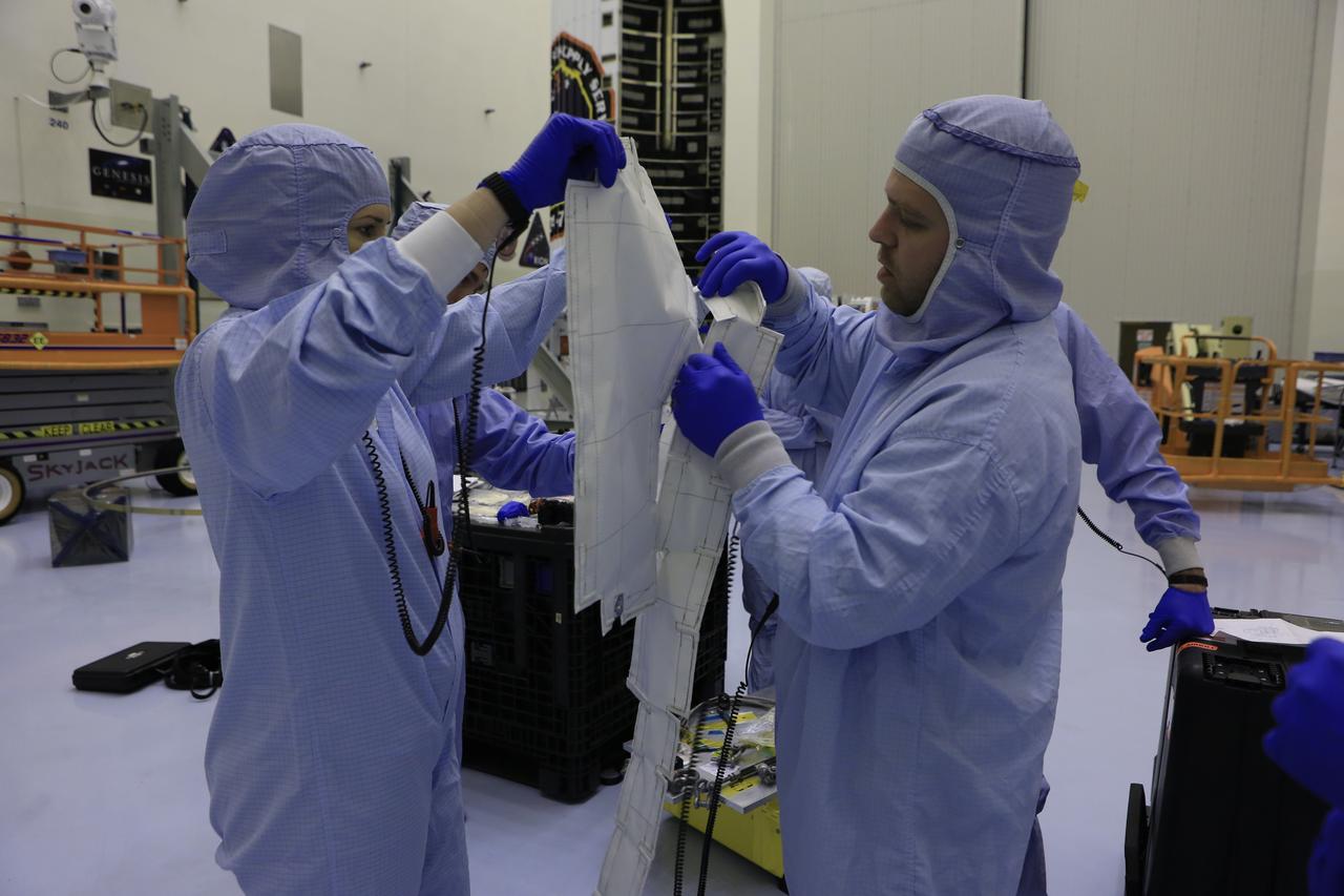 Inside the Payload Hazardous Servicing Facility at NASA's Kennedy Space Center in Florida, technicians prepare thermal blankets for several Nanoracks that will be installed on the exterior of the Orbital ATK Cygnus pressurized cargo module. The Orbital ATK CRS-7 commercial resupply services mission to the International Space Station is scheduled to launch atop a United Launch Alliance Atlas V rocket from Space Launch Complex 41 at Cape Canaveral Air Force Station no earlier than March 21, 2017. Cygnus will deliver 7,600 pounds of supplies, equipment and scientific research materials to the space station.